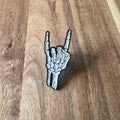 Nyssa rock pin featuring a detailed, metallic design, perfect for accessories or collectible display.