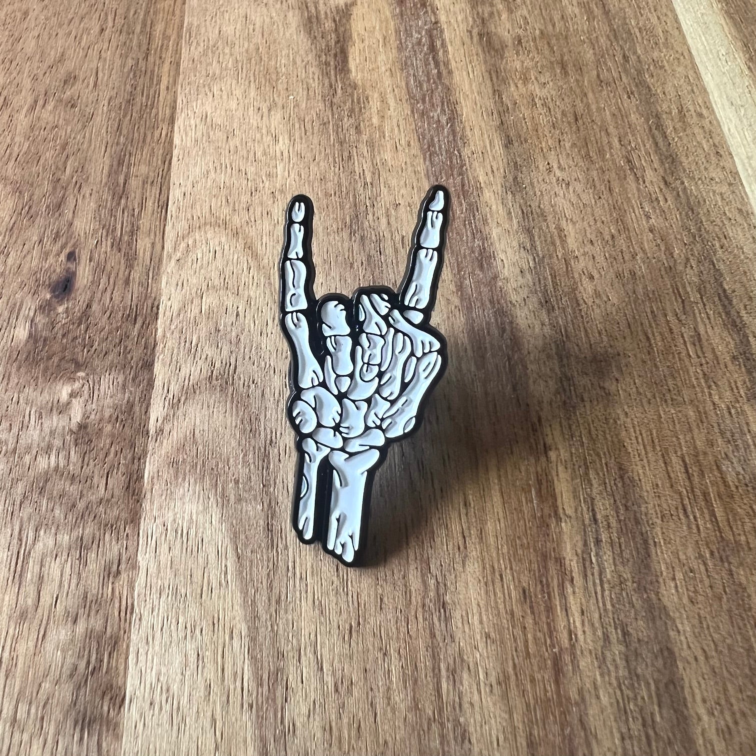 Nyssa rock pin featuring a detailed, metallic design, perfect for accessories or collectible display.